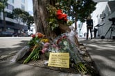 Flowers sit near the place where technology executive Bob Lee was fatally stabbed in San Francisco.