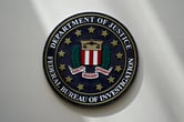 The FBI seal on a white wall.