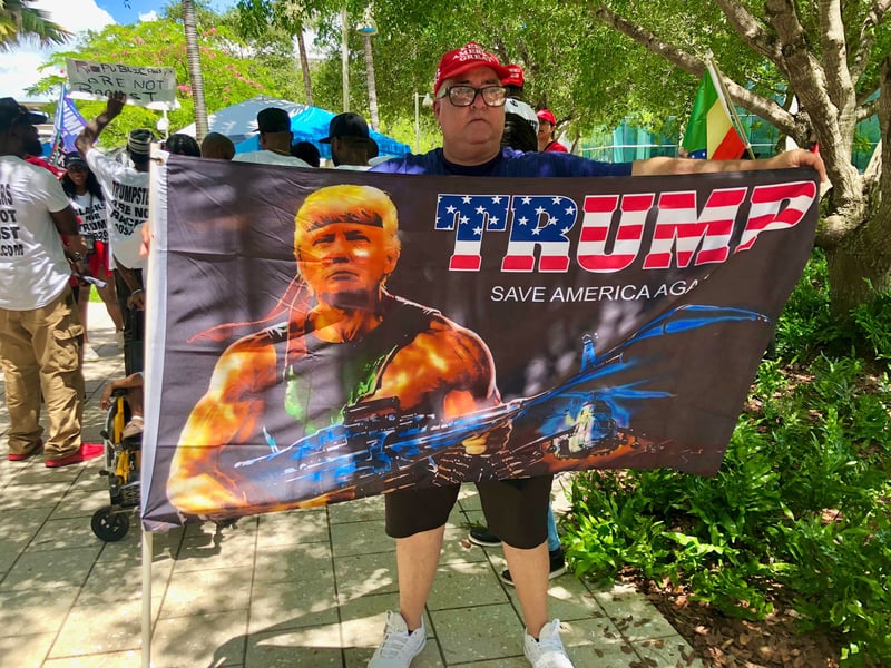 Trump supporter holding pro-Trump flag