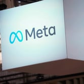 The Meta logo is displayed on a screen.