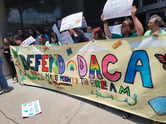 Supporters of the Deferred Action for Childhood Arrivals program hold up a banner outside the Houston federal courthouse on June 1, 2023.