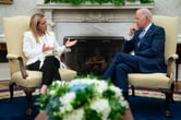 Giorgia Meloni and Joe Biden sitting in chairs in the Oval Office.