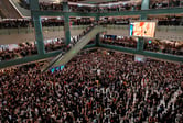 Thousands of protesters crowd multiple levels of a shopping mall in Hong Kong.