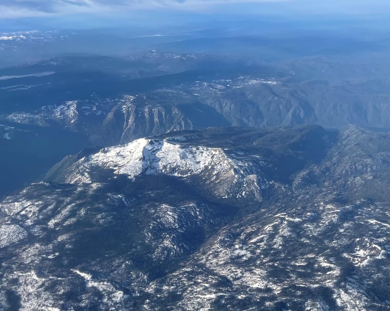 Snow-covered mountains seen from an airplane.
