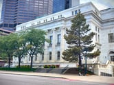East view of federal court in Denver surrounded by local trees.