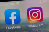 The app logos for Facebook and Instagram on the screen of a smartphone.
