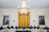 Joe Biden and Antony Blinken meet with more than ten people during an event in the East Room of the White House.