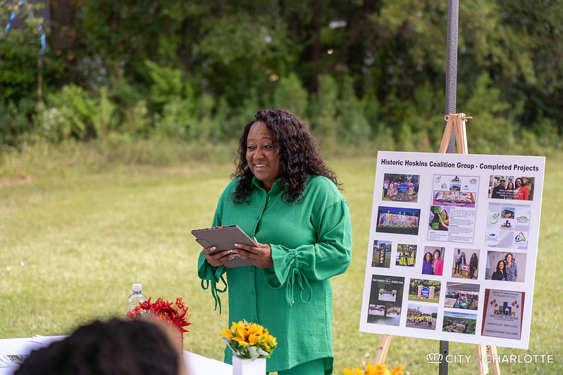 Beverly Knox Davis, a community activist and founder of the Historic Hoskins Coalition, speaks to a crowd celebrating the recent purchase and preservation of 32 affordable homes in the Hoskins neighborhood of Charlotte.