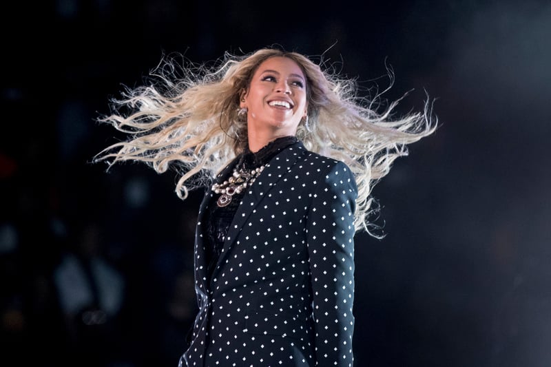 Beyoncé smiles while performing during a concert.