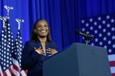A smiling woman at a podium.
