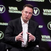 Elon Musk speaking in front of a backdrop reading VIVA Technology.
