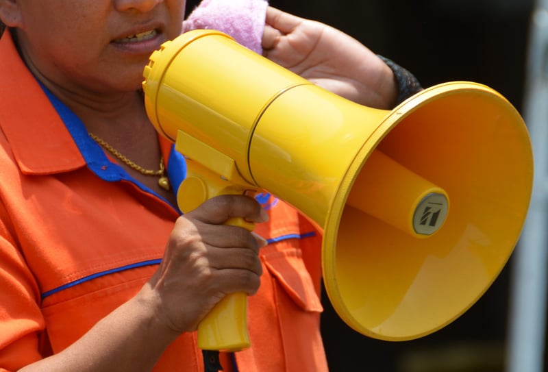 A person holds a megaphone