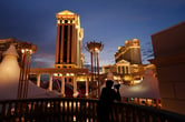 literature review on electronic voting machine A person takes photos of the Caesars Palace hotel and casino at night.