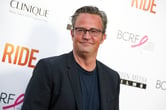 Matthew Perry smiles after arriving at the premiere of "Ride."