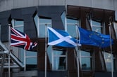 The flags of Britain, Scotland and European Union wave outside the Scottish Parliament building.