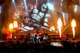 Members of the band Kiss perform on stage during a concert.