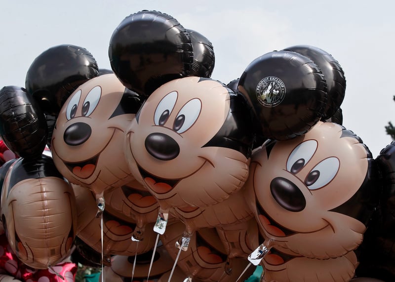 Eleven Mickey Mouse balloons, with the sky visible in the background.