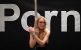 Ginger Banks stands next to a pole at the Pornhub booth at the AVN Adult Entertainment Expo.