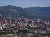 Buildings in front of a hillside.