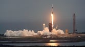A SpaceX Falcon 9 rocket lifts off from a launch pad at the Kennedy Space Center.