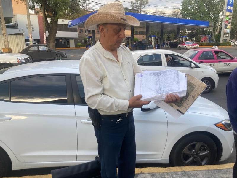 A man in Mexico City holds a map of Coyoacan.