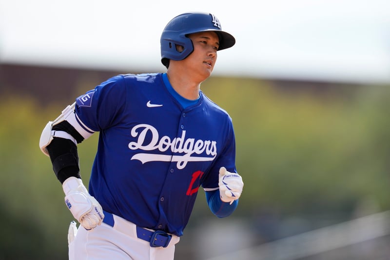 A man in an LA Dodgers uniform and batter's helmet runs.