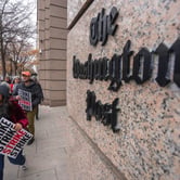 Washington Post employees hold signing while picketing outside the company's offices in downtown Washington.