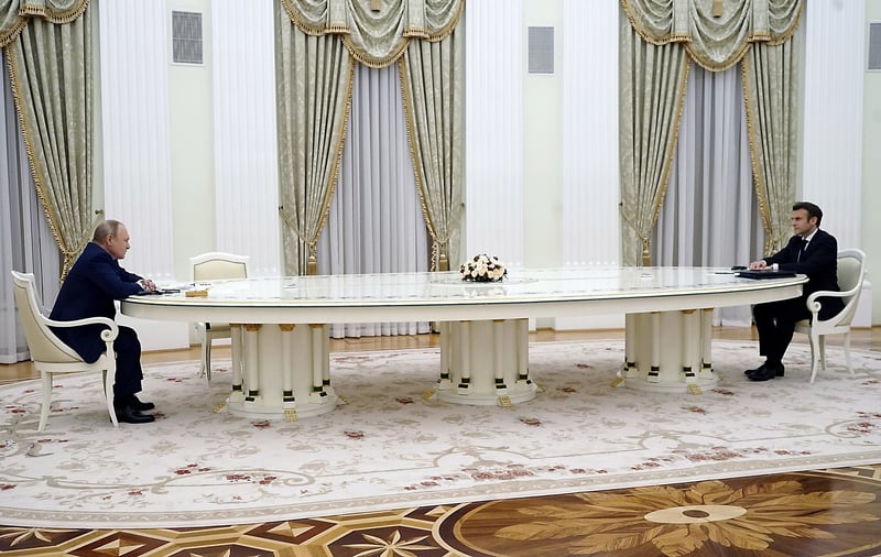 Macron and Putin meet at the Kremlin across a long table