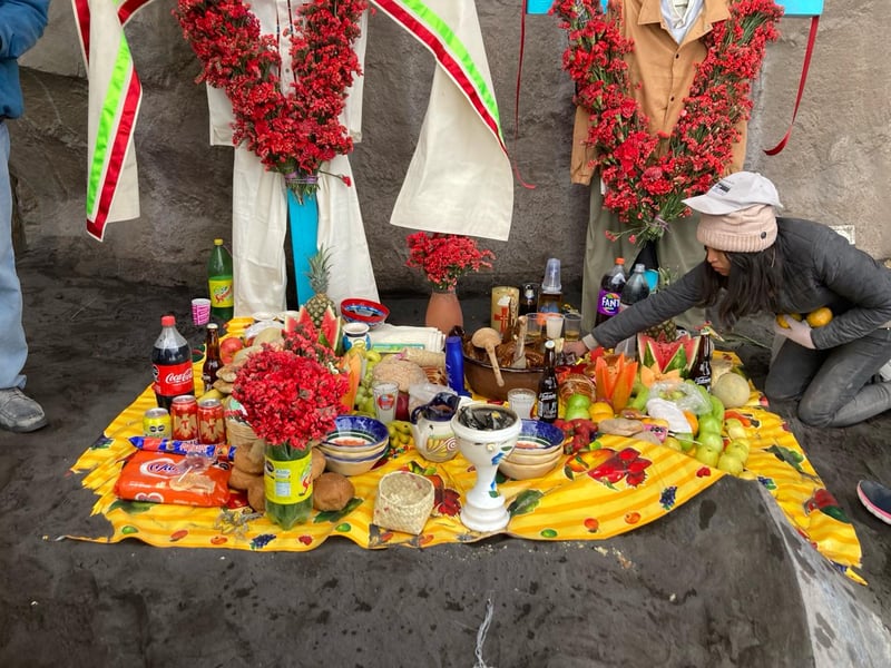 A colorful altar of food and offerings on a volcano. 