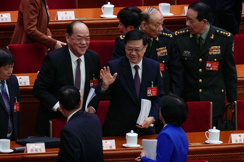 Hong Kong politicians and military leaders in a legislative setting.