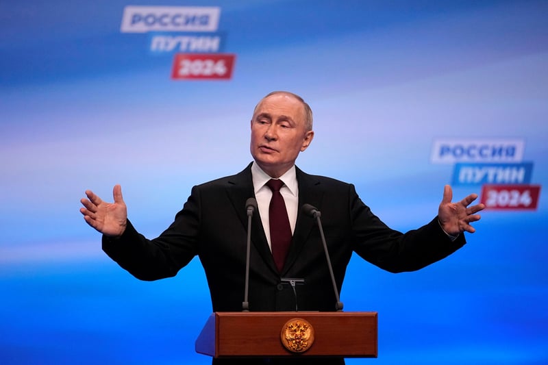 Vladimir Putin spreads his hands wide.