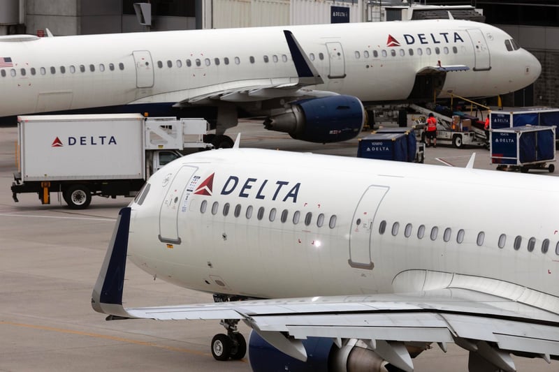 Two Delta Air Lines planes on a tarmac.