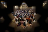 Dozens of Muslims pray in a mosque.