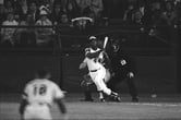 Hank Aaron reacts after hitting the ball during a Major League Baseball game.