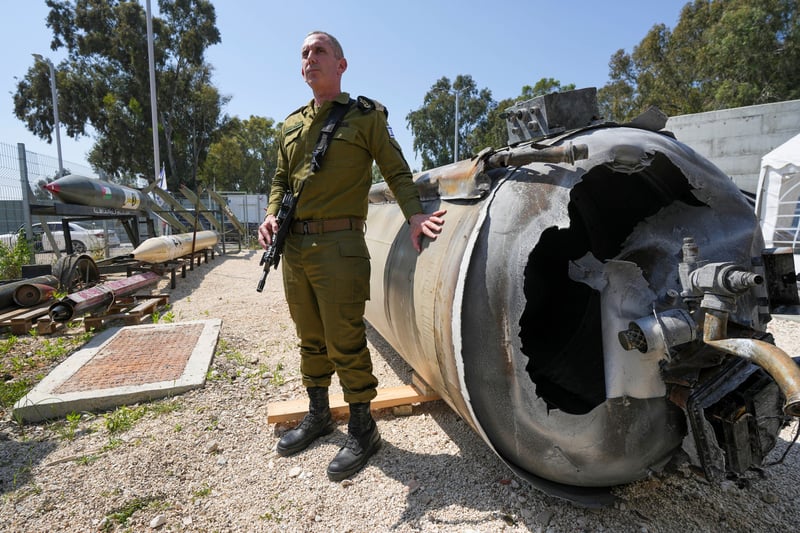 An Israeli officer stands near an intercepted missile.