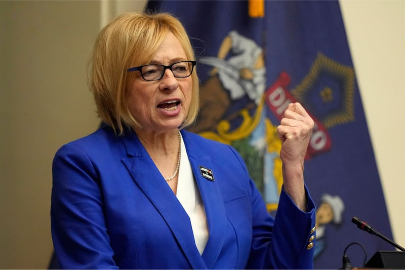 Janet Mills gestures with right left arm while delivering a speech.