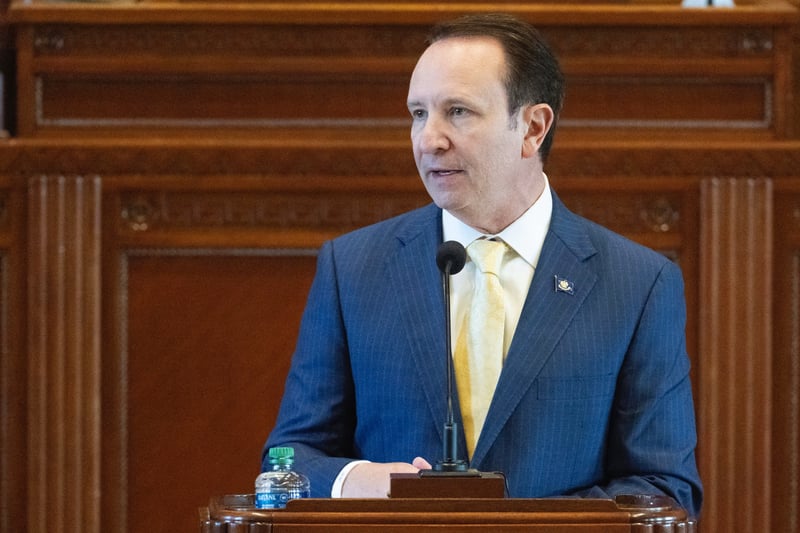 Jeff Landry speaks from behind a podium in the House chamber of the Louisiana state Capitol.