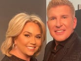 Julie and Todd Chrisley smile side by side in a close-up.