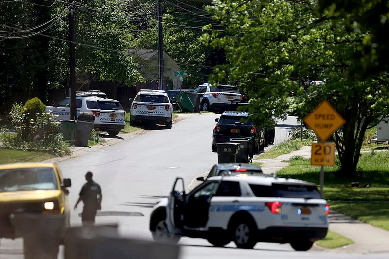 Several police vehicles parked along a street in a neighborhood in Charlotte, North Carolina.
