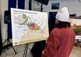 A woman looks at a map showing a proposed new community in Solano County, California.