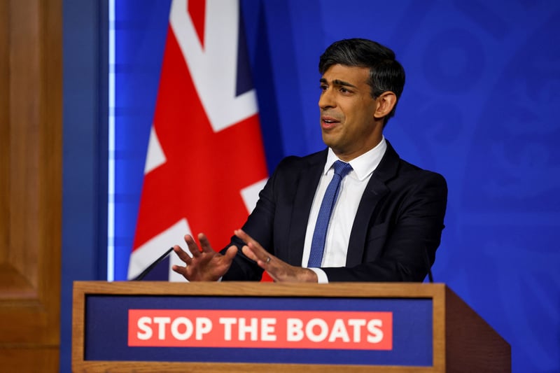 Rishi Sunak at a podium with a U.K. flag