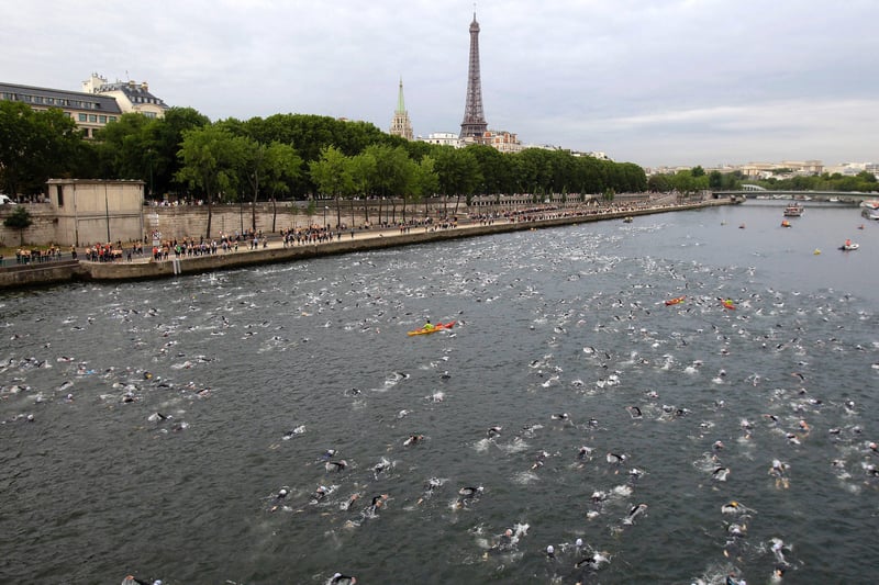 People swim in the River Seine during the Paris Triathlon.