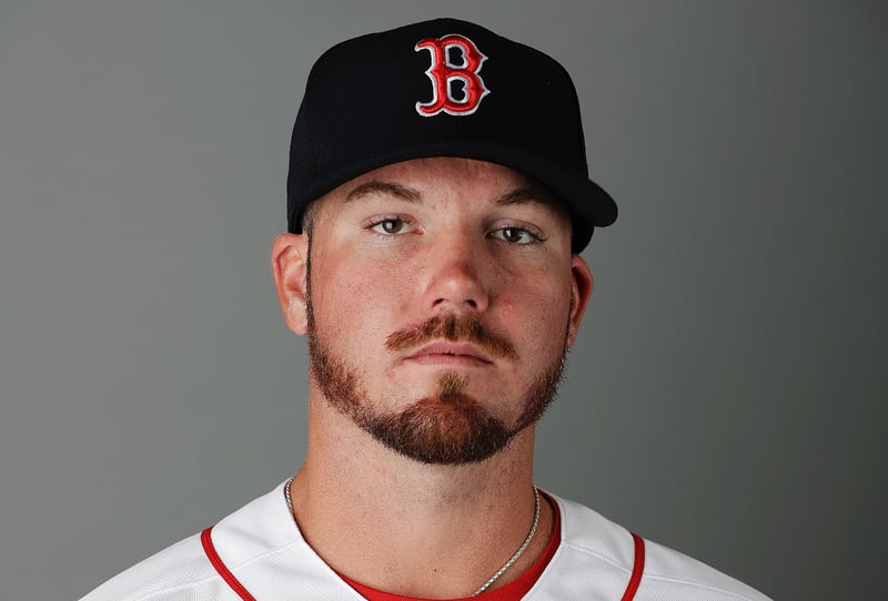 Austin Maddox poses for a photo while wearing a Boston Red Sox jersey and hat.