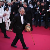 Francis Ford Coppola uses a cain to walk along the red carpet, with Adam Driver, Aubrey Plaza, Shia LaBeouf, more than a photographers and others behind him.
