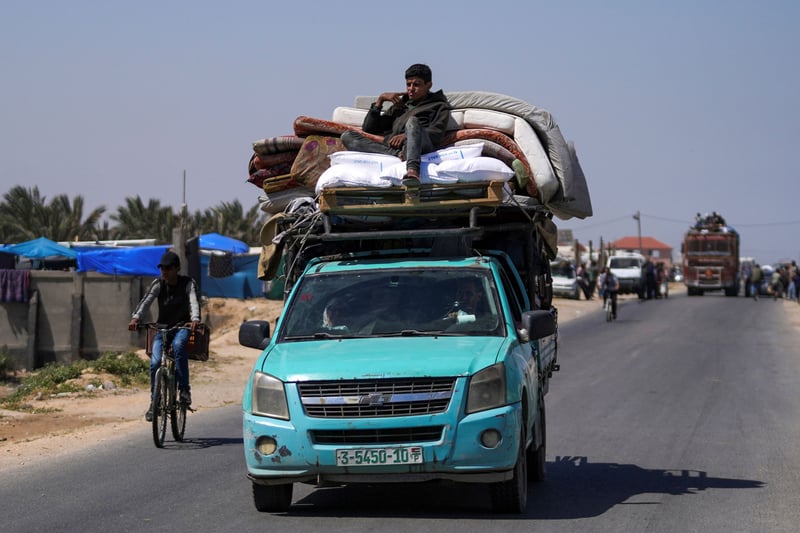 Palestinians fleeing Rafah by truck and bike.