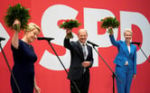 SPD candidates hold bouquets to celebrate the election