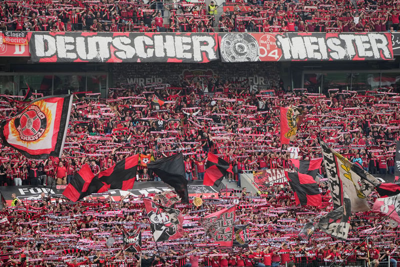 Bayer Leverkusen's stadium with fans in red and black.