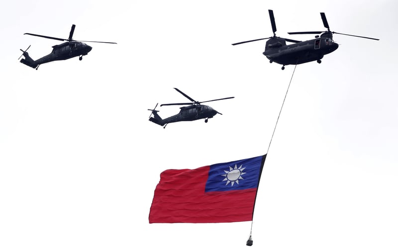 Helicopters flying a Taiwanese flag.