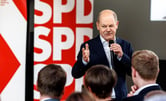 Olaf Scholz speaking by an SPD sign.
