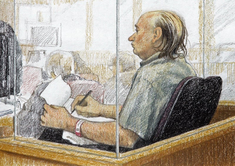 An artist's sketch of Robert Pickton taking notes during his trial.